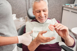 man holding denture